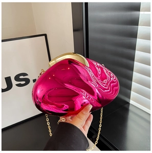 Detail of fuchsia pebble-shaped acrylic evening bag with gold chain and metal clasp