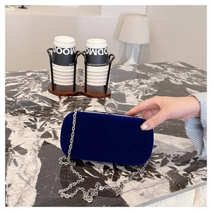 Detail of navy velvet evening clutch with crystal ring clasp and silver chain strap