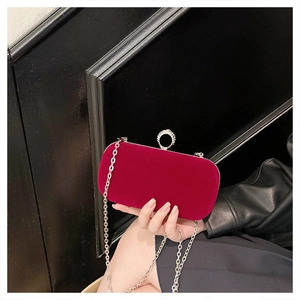 Detail of fuchsia velvet evening bag with silver chain and crystal-encrusted round clasp