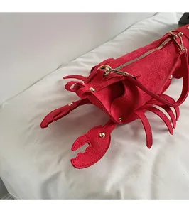 Detailed macro view of creative red lobster bag with golden zipper and suede texture