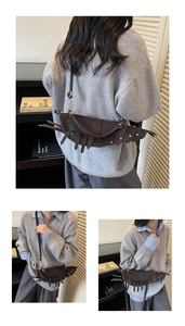 Detail of lobster-shaped crossbody bag showing faux suede texture and rivet accents