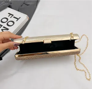 Detail showing simple interior lining and gold chain of the diamond clutch bag