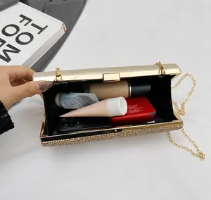 Macro view of gold sparkly evening clutch showing interior capacity and chain strap