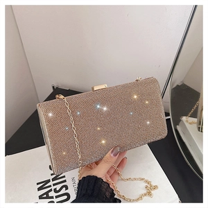 Detailed close-up of champagne gold rhinestones and gold metal clasp on evening clutch
