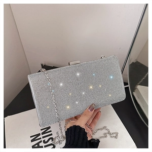 Close-up of sparkling silver rhinestone evening bag with elegant chain strap