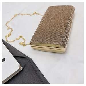 Detail view of the golden rhinestone dinner clutch with a sleek metal chain strap