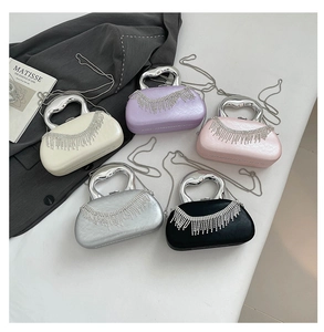 Detail of acrylic clutch bags with rhinestone fringes and heart handles in five colors