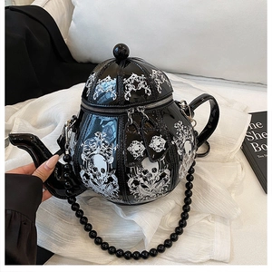 Detail of 3D teapot bag with skull print, glossy black finish and beaded shoulder strap