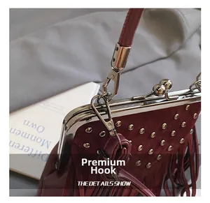 Detail of high-quality silver metal hook on a vintage burgundy fringe bag with rivets