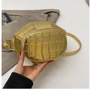 Detail of golden crocodile embossed texture and precision stitching on 3D bucket bag