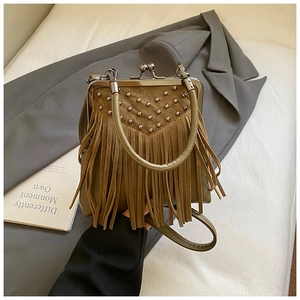 Detail view of khaki vintage fringe bag with metal rivets and retro clasp closure
