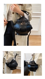 Detail of creative 3D teapot shape crossbody bag with embossed crocodile leather pattern