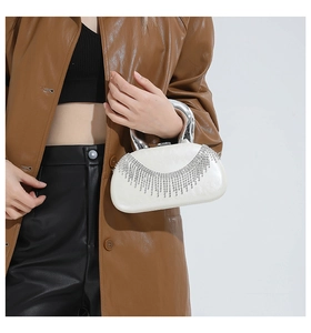 Chic white acrylic evening clutch featuring sparkling silver rhinestone tassels and metal handle