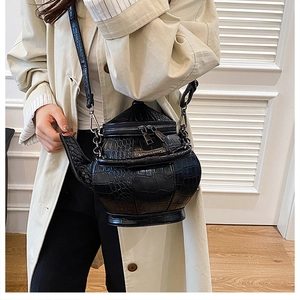 Detail of creative black crocodile pattern teapot-shaped crossbody bag with metal strap