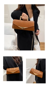 Detail showing brown lychee texture leather handbag with gold V-metal decor and chain