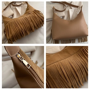 Detail view of brown hobo bag showing suede fringe and smooth leather texture finish
