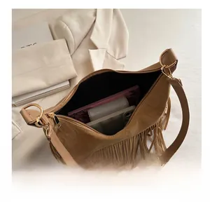 Interior view showing the large capacity of the brown suede fringe hobo bag
