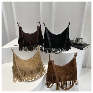 Detail of bohemian fringe crossbody bags in black, dark brown, beige, and caramel colors
