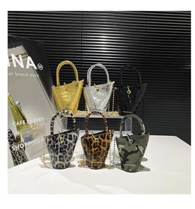 Mini bucket bags collection with leopard, camo and metallic finishes on display stands