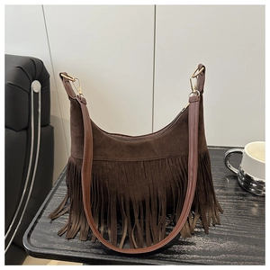 Detail of a brown suede hobo bag featuring retro fringes and golden metal hook hardware