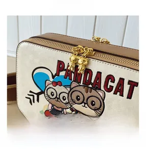 Detail of PANDACAT embroidered cartoon cats and bear-shaped metal zippers on crossbody bag