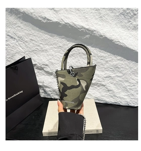 Detail view of mini camo bucket bag with metal chain strap and unique triangular shape