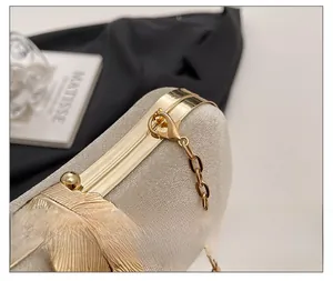 Close-up of golden leaf ornament and matte texture on elegant women dinner bag