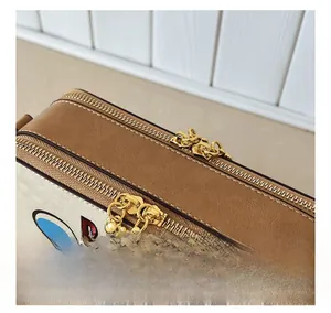 Macro detail of cartoon bear crossbody bag showing smooth dual metal zippers and PU leather trim
