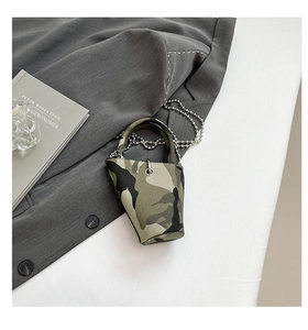 Detail of mini camo bucket bag with silver metal ball chain strap on a gray suit jacket