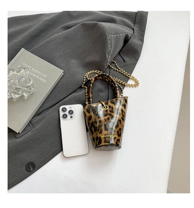 Mini leopard print bucket bag size comparison with smartphone on fashion layout