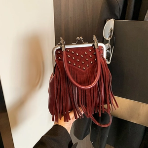 Vintage burgundy suede crossbody bag with metal rivets and long tassels on top handle