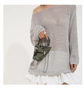 Detail of mini triangular camo bag with silver bead chain strap and top handle