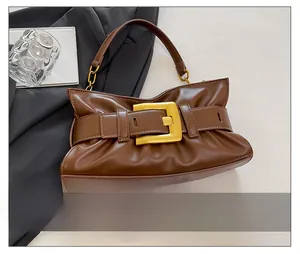 Brown lychee leather bag detail with gold buckle and pleated texture for commuting