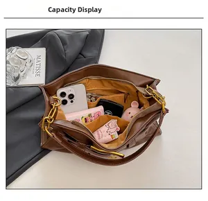 Top view of spacious brown leather tote bag interior with pockets and daily essentials