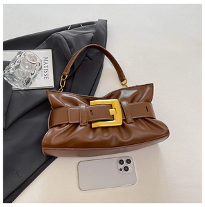 Close-up of dark brown pleated cloud bag with elegant gold buckle and chain details
