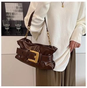 Detail of gathered dark brown leather bag with a large vintage gold square buckle