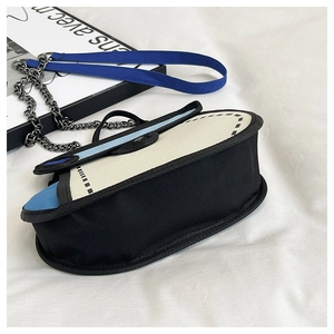 2D cartoon style shoulder bag featuring blue patchwork and metal chain strap detail