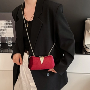 Elegant red velvet evening bag with gold leaf clasp and chain strap for women