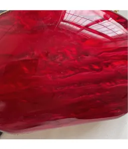Macro shot of red marble pattern acrylic surface with glossy resin texture