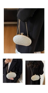 Detail of white marble acrylic evening bag with gold chain and diamond buckle