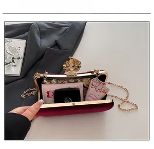 Macro view showing the capacity of a wine red velvet evening clutch with gold metal frame