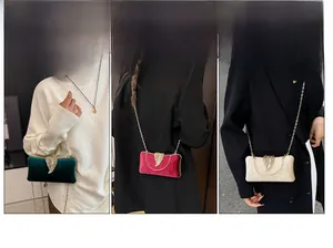Three elegant velvet evening bags with golden feather clasps and chain straps