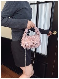 Pink faux fur handbag with silver sequins and metal chain strap shown in a lifestyle setting