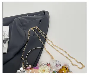 Detailed macro view of the gold chain strap and 3D floral petals on this evening bag