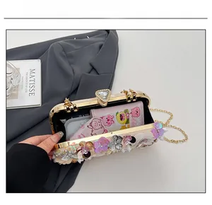 Detail showing the inner capacity of this floral evening bag with its elegant chain strap