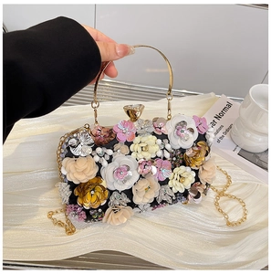 Detail of multi-color 3D fabric flowers, rhinestones, and pearls on elegant evening clutch