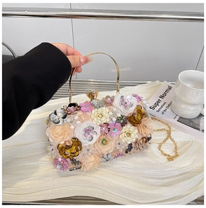 Detailed close-up of champagne evening clutch with 3D floral sequins and pearl accents