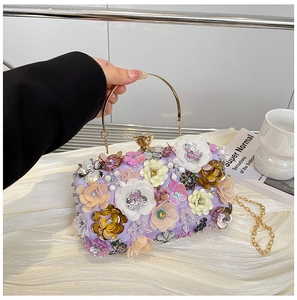 Detail of lavender evening clutch with 3D handmade flowers, sequins, and pearls