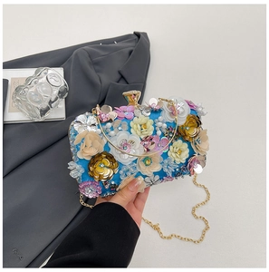 Detailed view of floral evening clutch bag with sequins, beads and gold chain strap