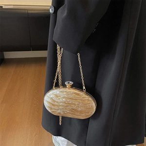 Elegant champagne gold marble acrylic evening bag with metal frame and chain strap